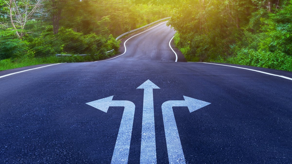Arrows on asphalt road ground with three direction arrow choices, left, right or move forward on Curve of the road